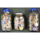 Three large glass jars full of pin badges (3)