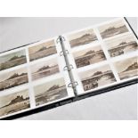 Folder containing approximately two hundred postcards of Bamburgh Castle