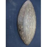 Large oval tribal possible Aboriginal type shield with internal handle and carved pattern to the