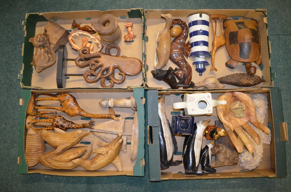 Four boxes of hand carved ornaments, mostly wooden, including a giraffe, dolphin, octopus etc., a