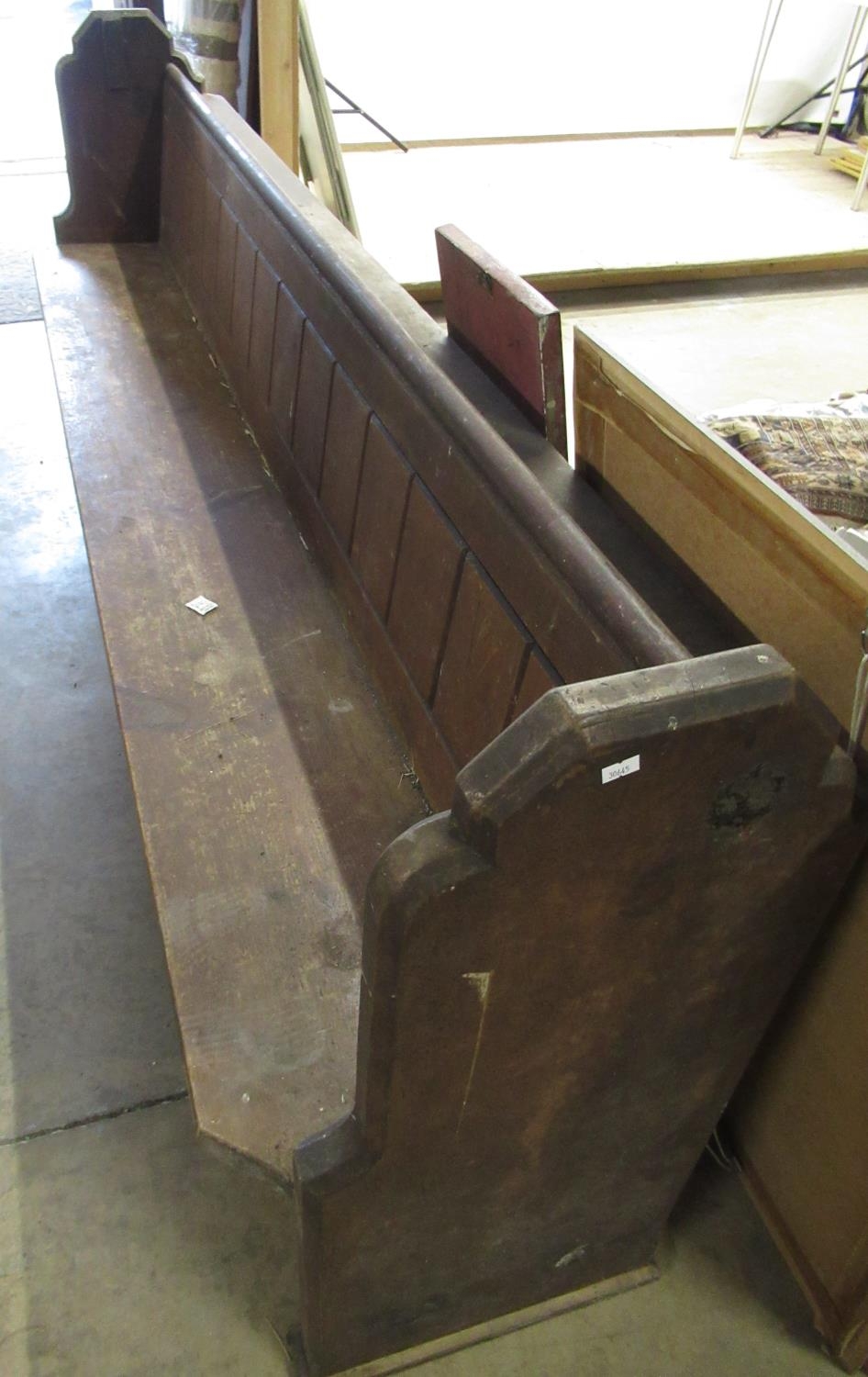 Victorian pine church pew, with panel back and solid seat on shaped end supports, W250cm D46cm H92cm