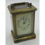 Brass cased carriage clock, dial marked Finnigan's Ltd Manchester & Liverpool, complete with key and