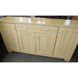 Modern beech laminate sideboard with central drawer above two cupboard doors flanked by two other