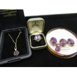 9ct yellow gold necklace with round cut purple stone in a pierced mount, a yellow metal ring with