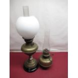 Brass oil lamp on black terracotta base with chimney and white globe shade, and a Veritas brass