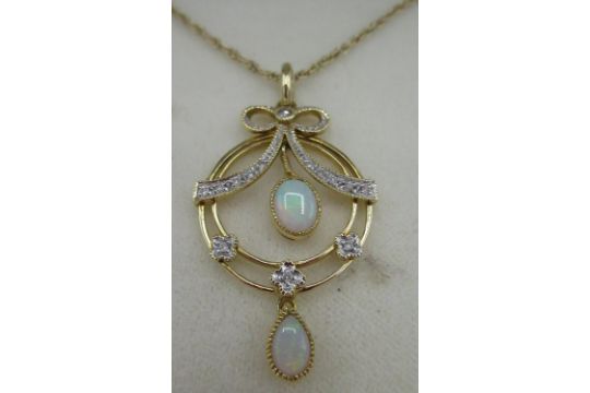 Hallmarked 9ct yellow gold opal and diamond circular pendant, round cut diamonds inset in ribbon - Image 2 of 2