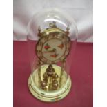 Kundo Torsion clock with four ball pendulum, floral decorated enamel dial and base under glass dome,
