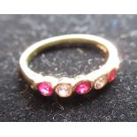 Hallmarked 18ct yellow gold diamond and ruby half eternity ring size K, 2.5g