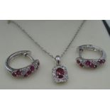 9ct white gold ruby and diamond hoop earrings inset with seven rubies and ten round cut diamonds and