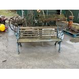 Garden bench with wooden slats and scroll design metal ends