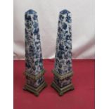 Pair of modern blue and white pottery obelisks on brass pierced bases with scroll feet, H36cm (2)