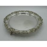 Early C20th silver plated circular salver of with raised grape and vine border on three bunch of
