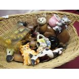 Collection of cat figures in a wicker basket
