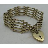 Hallmarked 9ct yellow gold five bar gate bracelet with heart padlock clasp and safety chain by (