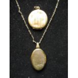 Rolled yellow gold locket with bright cut front on yellow metal chain, and another rolled gold