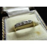 Yellow metal diamond five stone ring, graduated round cut diamonds inset in a platinum mount,