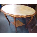 Edwardian walnut two-tier occasional table, with pie crust edge oval top on angular cabriole