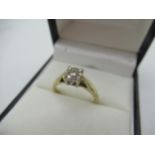 Hallmarked 9ct yellow gold diamond ring with a central round cut diamond and a halo of eight smaller