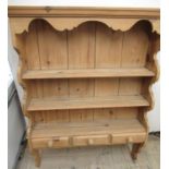 Waxed pine three tier wall rack, moulded cornice and three spice drawers with turned wooden handles,