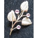 Hallmarked 9ct yellow gold flower and leaf bar brooch with round cut, claw set lilac stones (maker