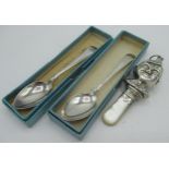 Geo.V hallmarked Sterling silver baby soother with elf head mounts and mother of pearl handle by W H