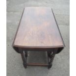 C20th oak gate legged table, with two D shaped leaves on barley twist and block supports joined by