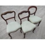Pair of Victorian mahogany balloon back dining chairs and another similar chair, all upholstered