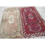 Caucasian red ground multicolored rug, field with geometric medallion within a repeating border,