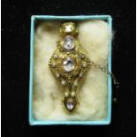 Victorian yellow metal brooch with twelve seed pearls inset in filigree mount with three oval cut