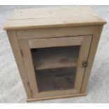 Small pine cupboard, with glazed door and single shelf on plinth base W66cm D38cm H86cm