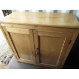 Victorian and later waxed stripped pine cupboard with interior shelves and two panel doors W108cm