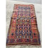 Caucasian multicoloured rug, field with geometric medallions and a striped border L222cm W118cm
