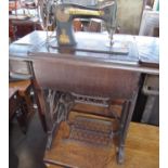 Vintage Singer treadle sewing machine on cast iron and oak base, no. Y7204562, with accessories