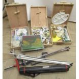Three wooden traveling table top artist easel boxes, with paints and brushes, two metal