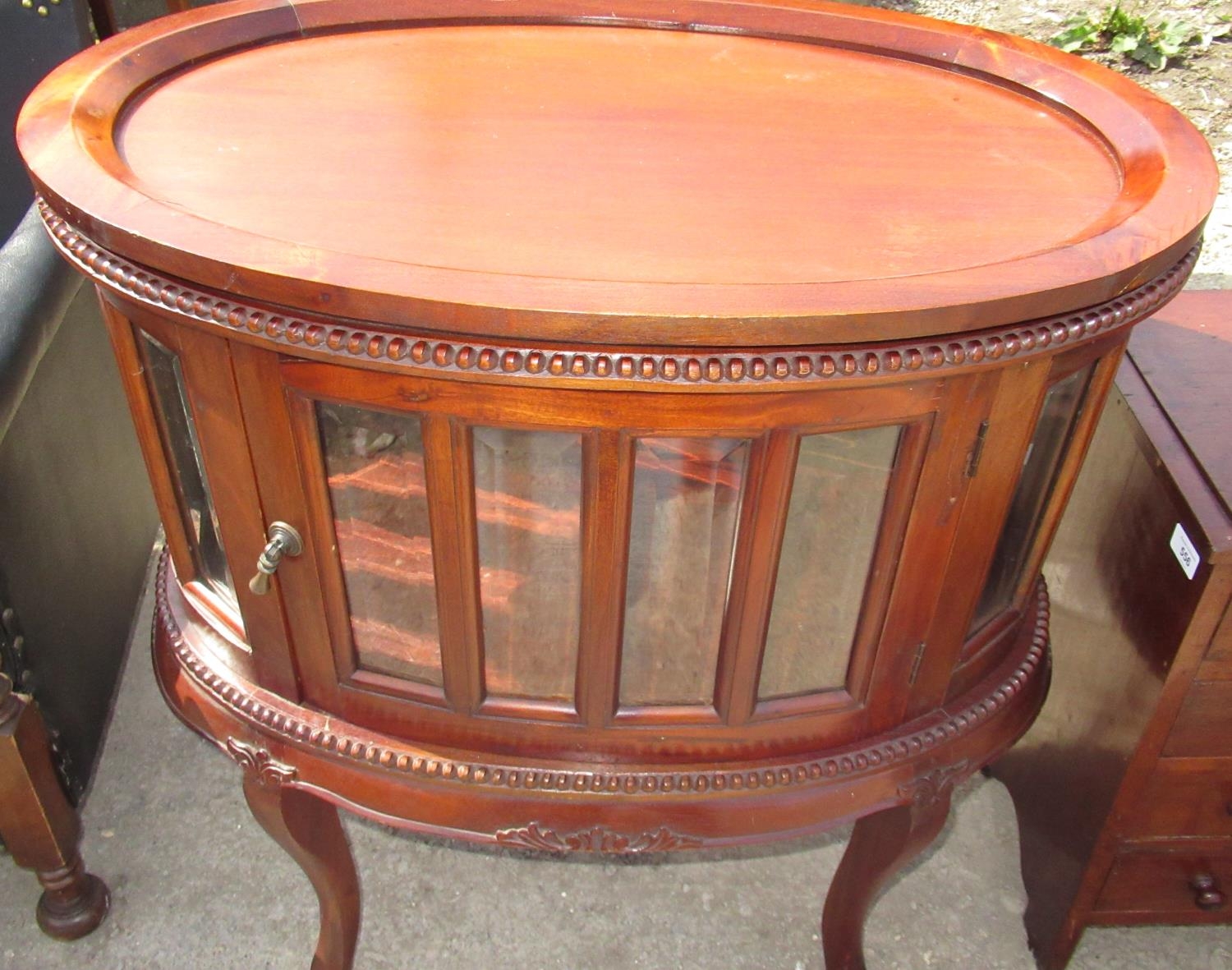 French style oval drinks cabinet, with tray oval top and glazed panel doors on cabriole legs,