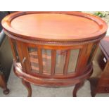 French style oval drinks cabinet, with tray oval top and glazed panel doors on cabriole legs,