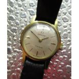Ladies Omega Geneve wristwatch, gold plated case on black leather strap with snap on stainless steel