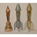 3 cast metal rocket money banks, 2 Berzac Creations Astro MFG (E.Detroit, USA). Missing nose tips,