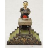 Vintage metal Magician coin bank, written to the base "Reproduced From original in Collection of The