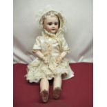 SFBJ French bisque headed doll model 301, with peirced ears and articulated limbs, wearing lace