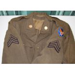 Three US four pocket tunics with insignia, one with sergeant stripes and insignia, brass lapel