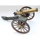 Cast metal model of an 1883 Gatling Gun, L38cm (wheel snapped at joint with old glue mark, will