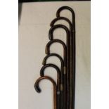 Set of seven walking canes four with metal mounted handles and metal collars