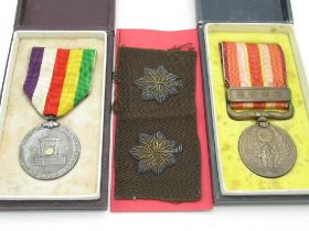 Two cased Japanese WWII period service medals, pair of Japanese cloth collar dogs (3)