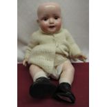 Heubach Koppelsdorf model 300.2 bisque headed doll, wearing a knitted dress and jacket with patent