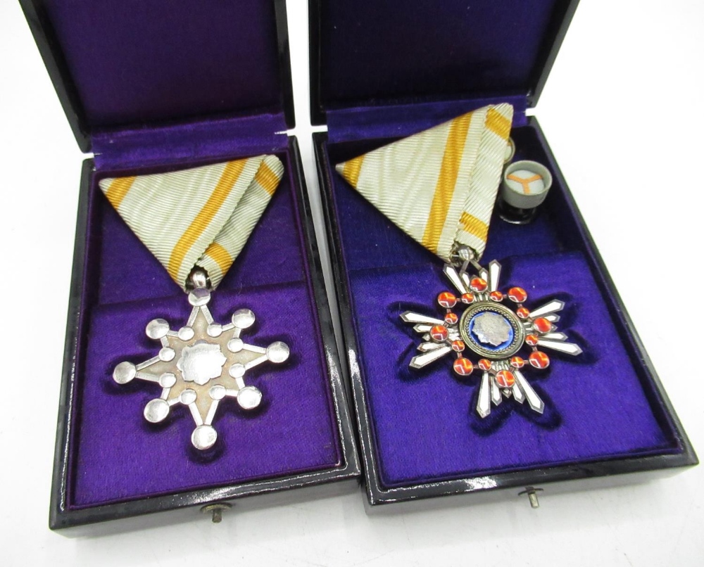 Two cased Japanese WWII period medals comprising of Sacred Treasure Sixth Class and Sacred