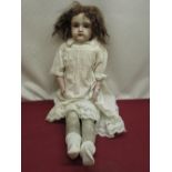 Kestner bisque headed doll marked Dep 10 154 to neck, wearing brown wig and white dress, H64cm