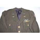 Two US airforce uniforms with brass buttons, lapel insignia, silver wings and medal ribbon