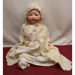 Armand Marseille model 351/5k bisque headed doll wearing white satin bonnet and cotton dress with