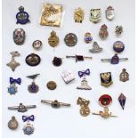 Selection of enamel regimental, sweetheart and civilian association badges, many hallmarked